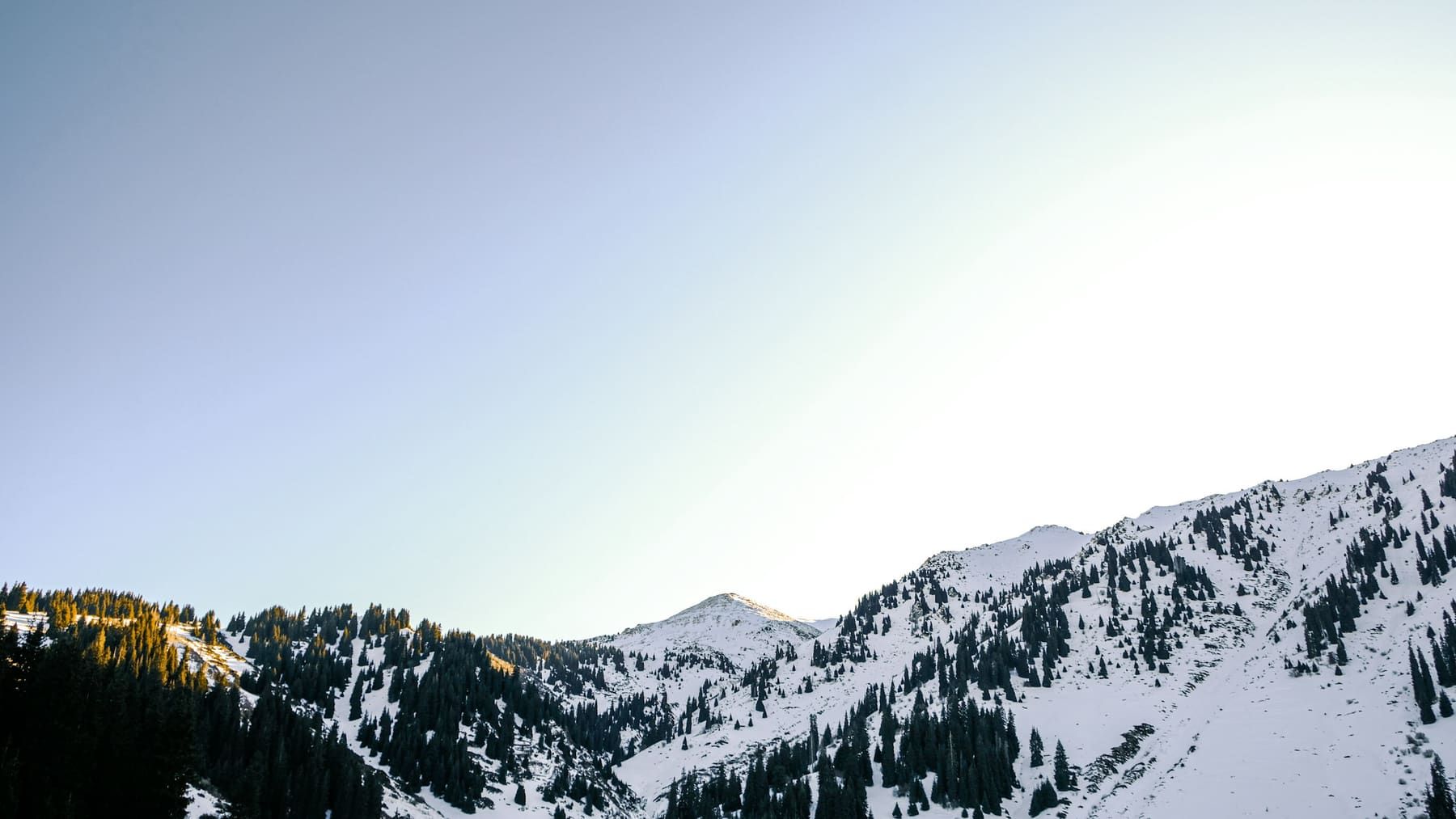 Snow-covered mountain ridge at first light
